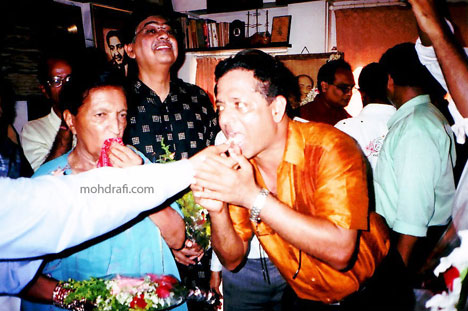 Birthday cake being shared, Binu Nair and Mubarak Begum seen in the picture